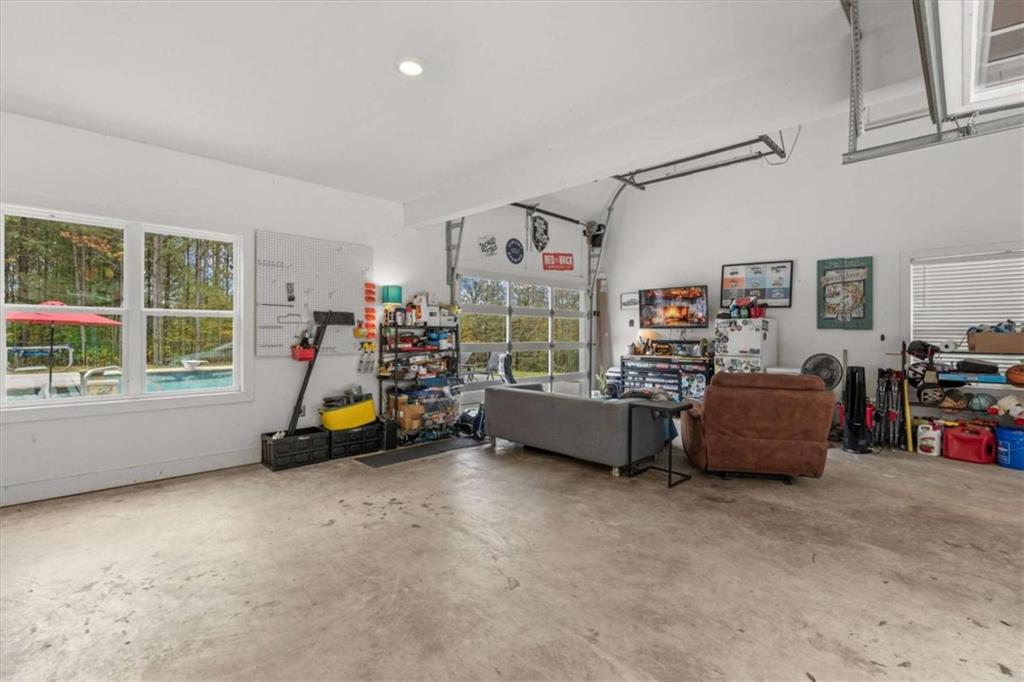 1233 Whooping Creek Road Carrollton, GA 30116 - Photo 50 of 61 a living room with furniture and a flat screen tv
