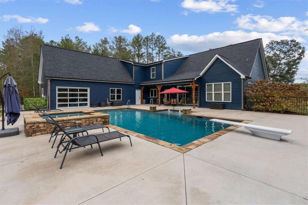 1233 Whooping Creek Road Carrollton, GA 30116 - Photo 5 of 61 a swimming pool with outdoor seating and yard in the back
