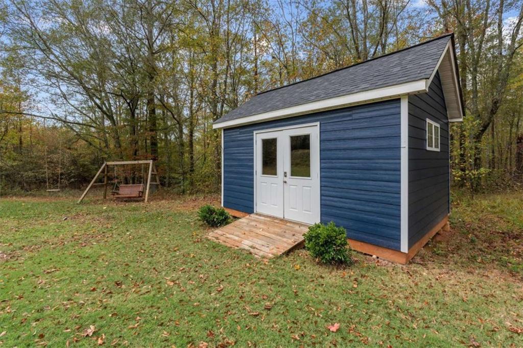1233 Whooping Creek Road Carrollton, GA 30116 - Photo 56 of 61 a backyard of a house with lots of green space