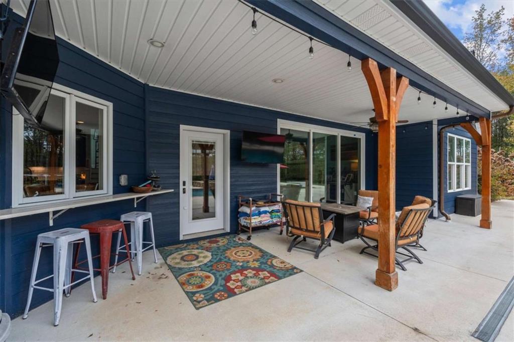 1233 Whooping Creek Road Carrollton, GA 30116 - Photo 6 of 61 a view of a dinning table and chairs in patio