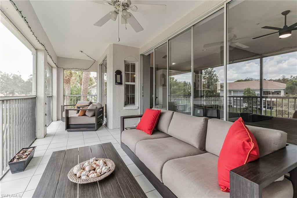 6895 Rain Lily Road, Unit 203 Naples, FL 34109 - Photo 12 of 22 a living room with furniture and a large window