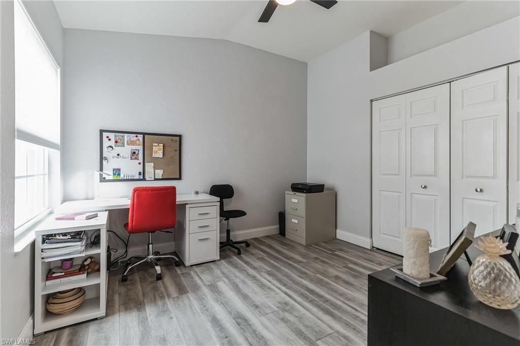 6895 Rain Lily Road, Unit 203 Naples, FL 34109 - Photo 13 of 22 a view of a workspace with furniture and wooden floor