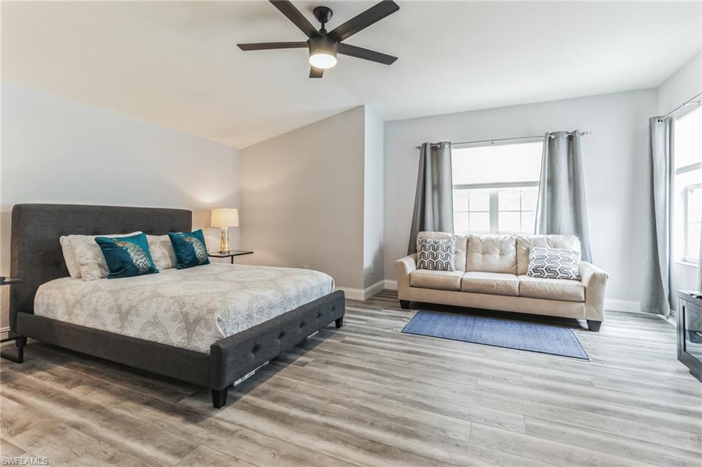 6895 Rain Lily Road, Unit 203 Naples, FL 34109 - Photo 15 of 22 a bedroom with a bed and a couch