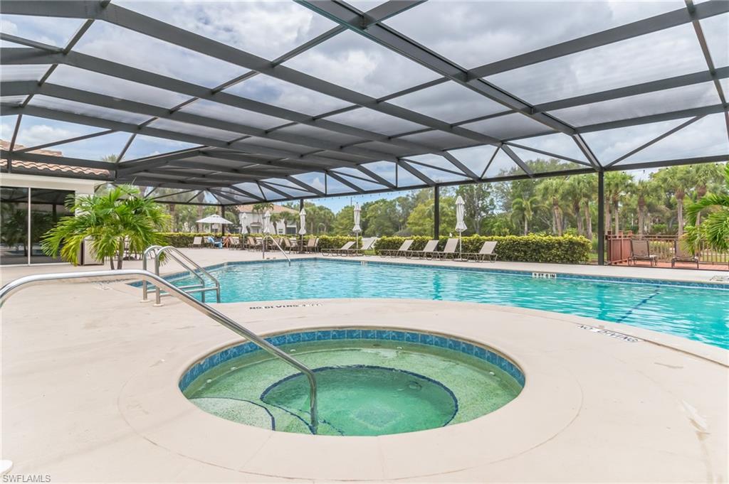 6895 Rain Lily Road, Unit 203 Naples, FL 34109 - Photo 20 of 22 a view of a swimming pool with a yard