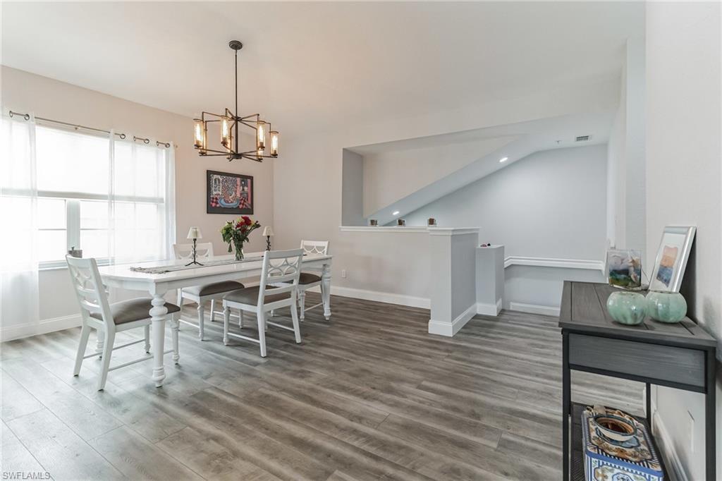 6895 Rain Lily Road, Unit 203 Naples, FL 34109 - Photo 2 of 22 a view of a dining room with furniture window and wooden floor