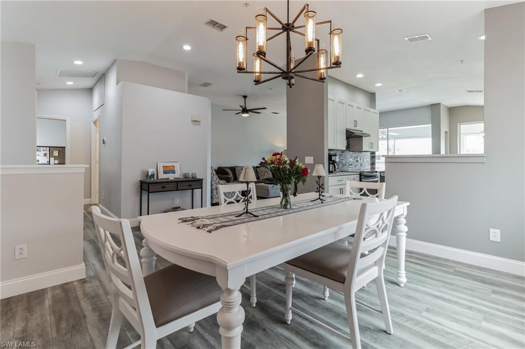 6895 Rain Lily Road, Unit 203 Naples, FL 34109 - Photo 3 of 22 a view of a dining room with furniture