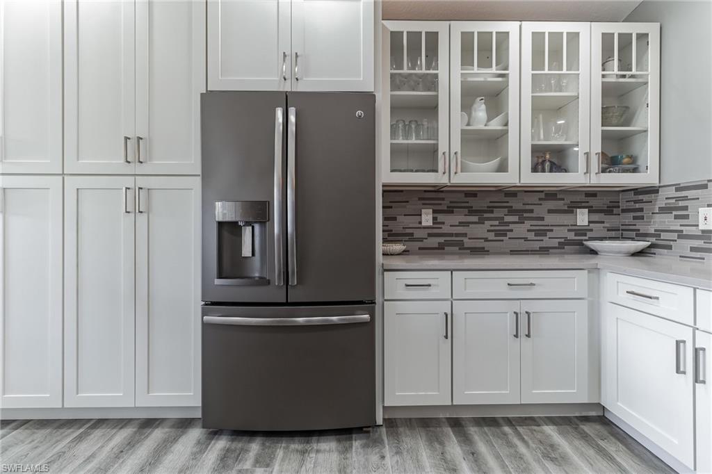 6895 Rain Lily Road, Unit 203 Naples, FL 34109 - Photo 6 of 22 a kitchen with cabinets and stainless steel appliances