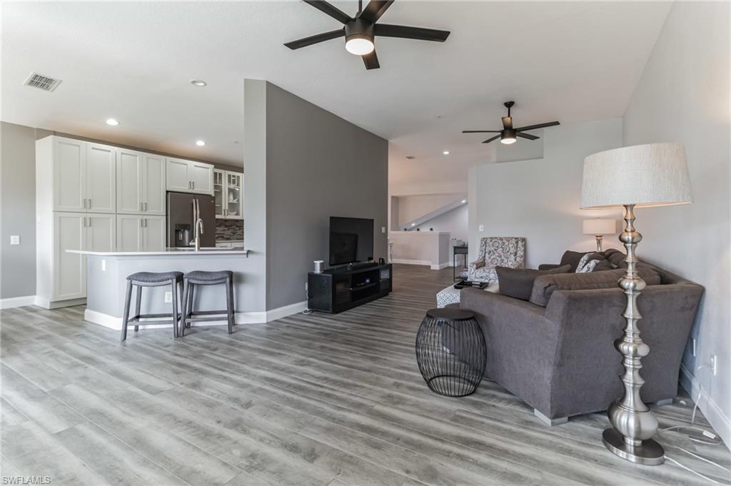6895 Rain Lily Road, Unit 203 Naples, FL 34109 - Photo 9 of 22 a living room with furniture and a wooden floor