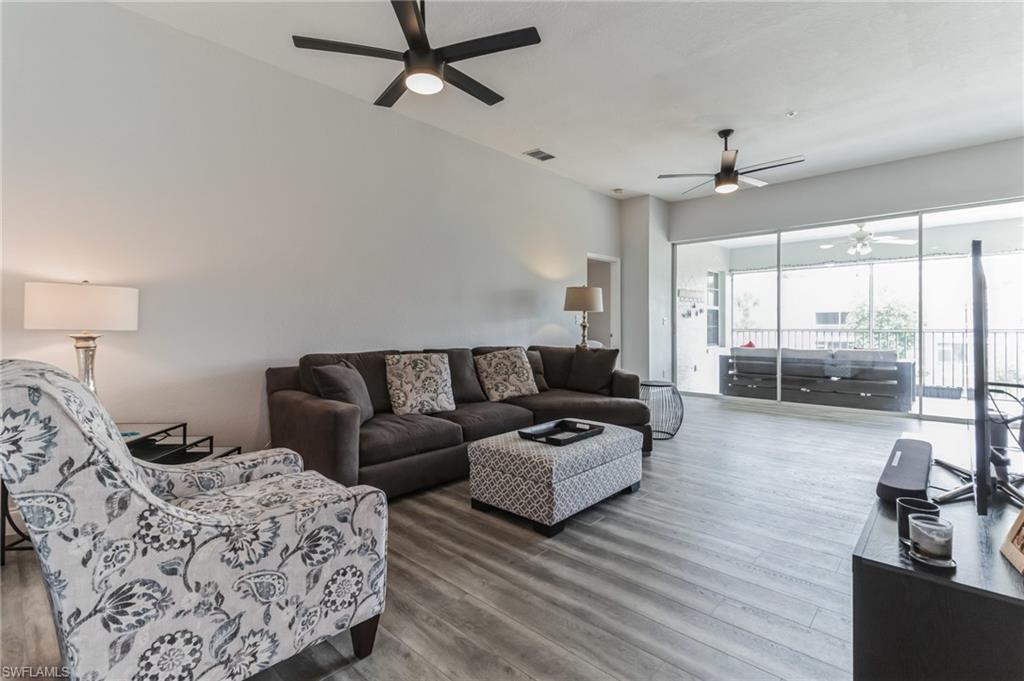 6895 Rain Lily Road, Unit 203 Naples, FL 34109 - Photo 10 of 22 a living room with furniture and a large window