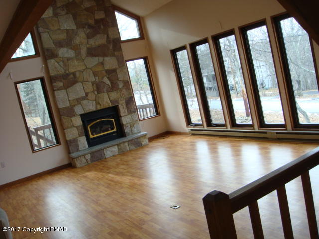 1114 Hampstead Road Bushkill, PA 18324 - Photo 4 of 29 a view of an empty room with wooden floor and windows