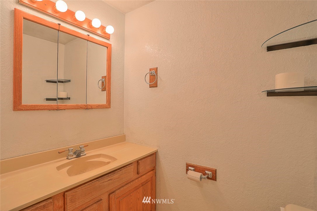 3601 Northeast 10th Street Renton, WA 98056 - Photo 16 of 25 a bathroom with a granite countertop sink and a mirror
