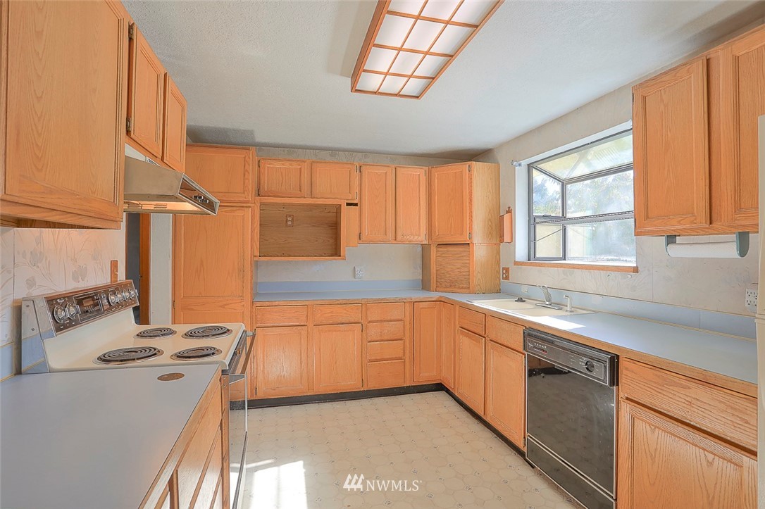 3601 Northeast 10th Street Renton, WA 98056 - Photo 8 of 25 a kitchen with stainless steel appliances granite countertop a sink and a stove