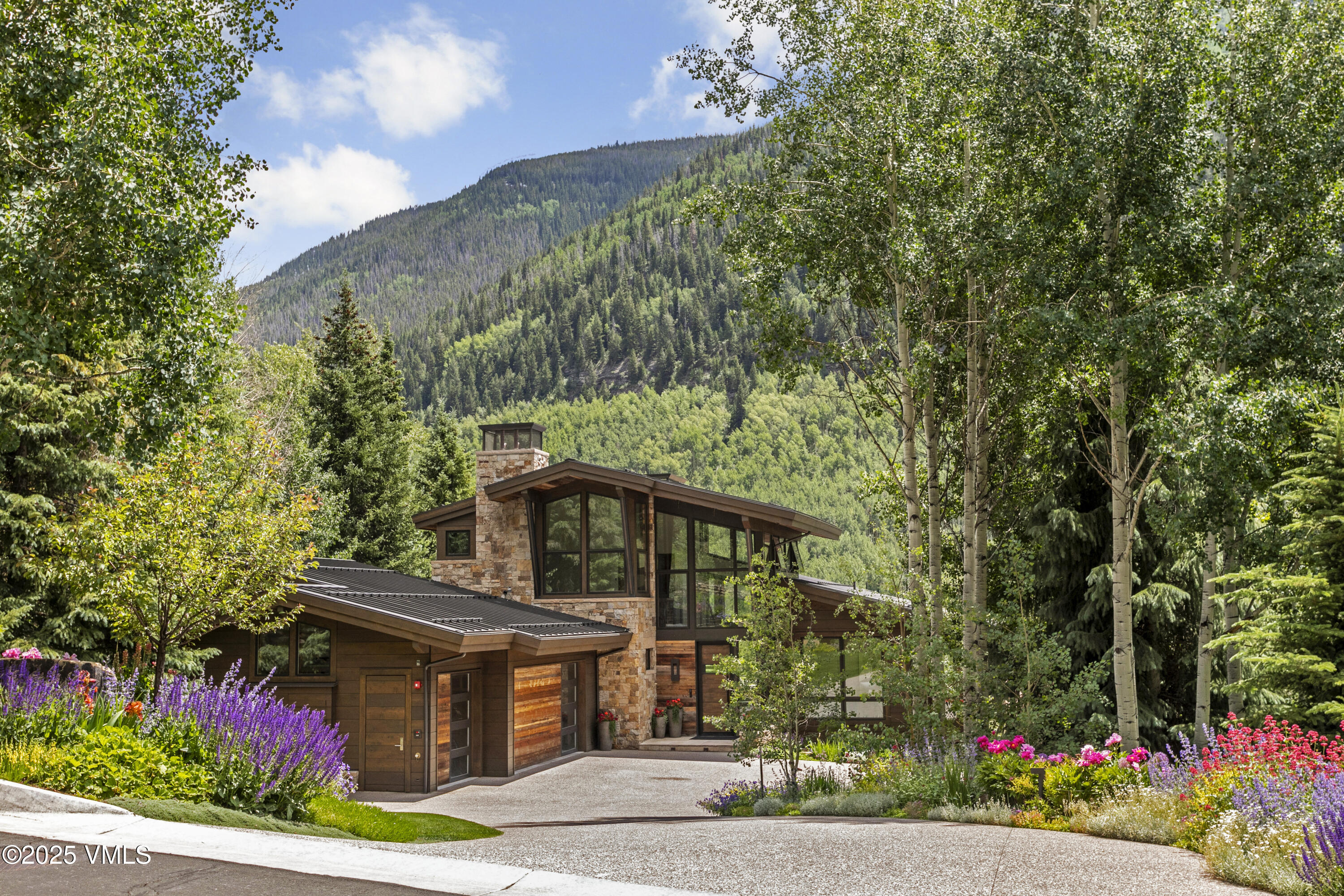 2470 Bald Mountain Road Vail, CO 81657 - Photo 1 of 29 a front view of a house with a garden