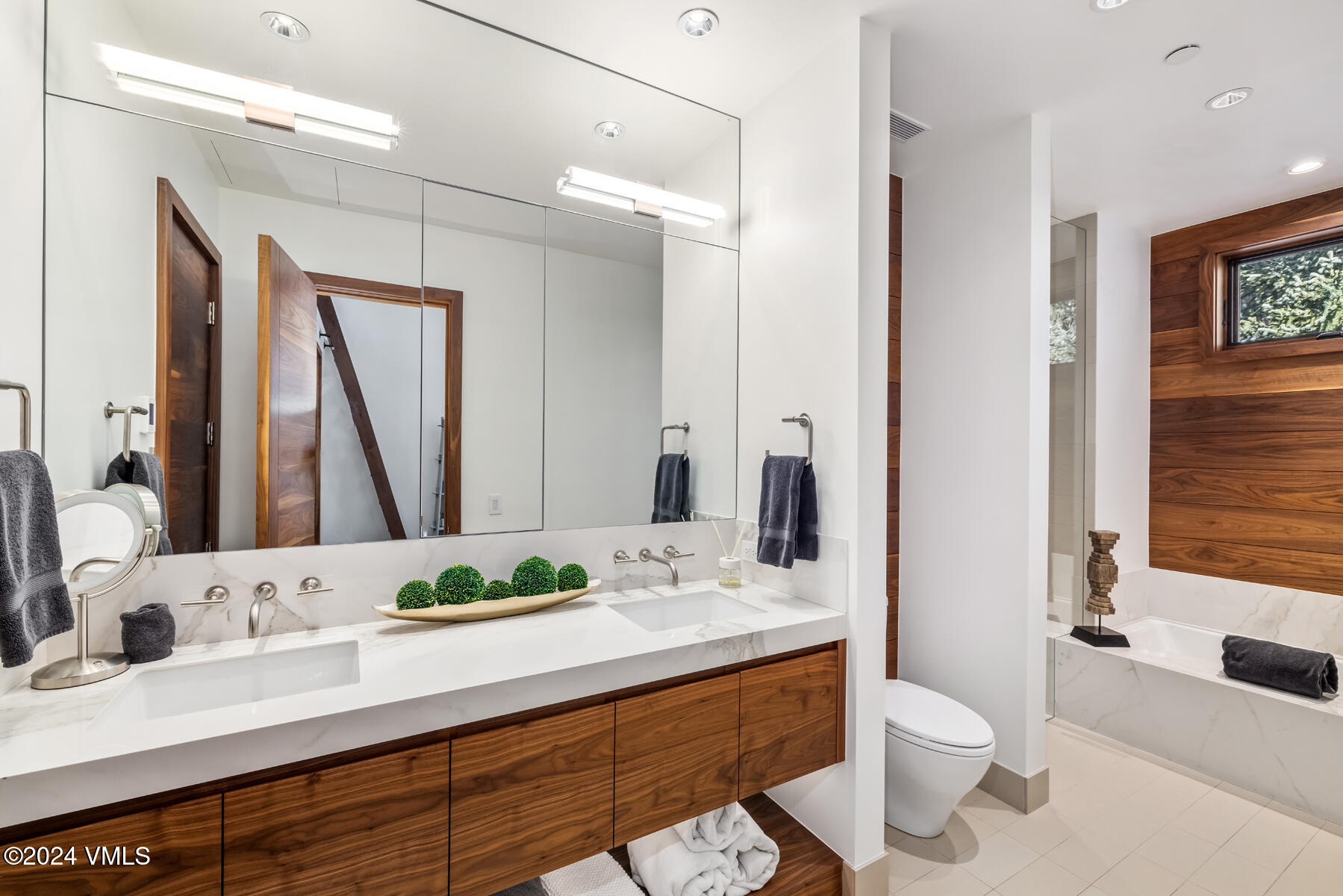 2470 Bald Mountain Road Vail, CO 81657 - Photo 17 of 29 a bathroom with a granite countertop sink mirror vanity and toilet