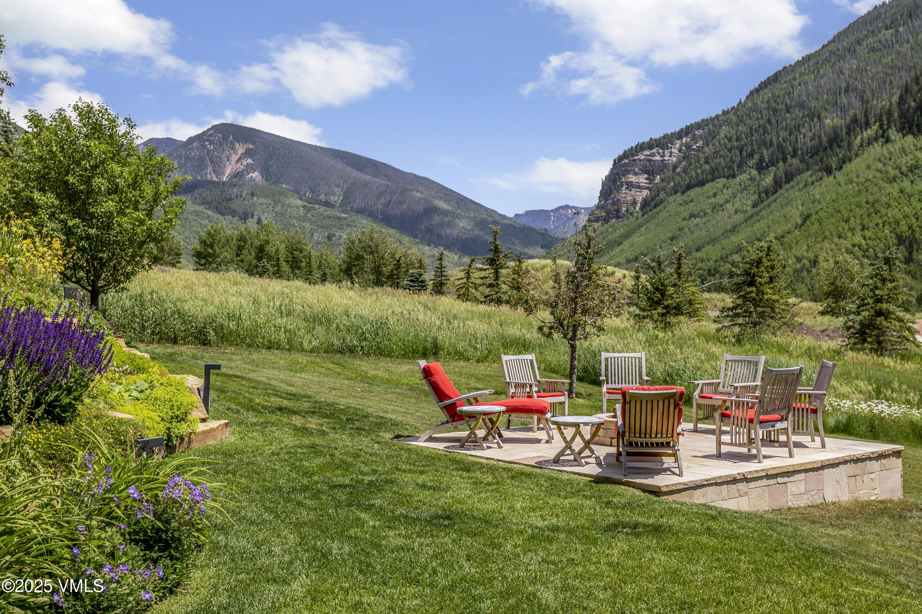2470 Bald Mountain Road Vail, CO 81657 - Photo 27 of 29 a chair and table sitting in middle of the green field