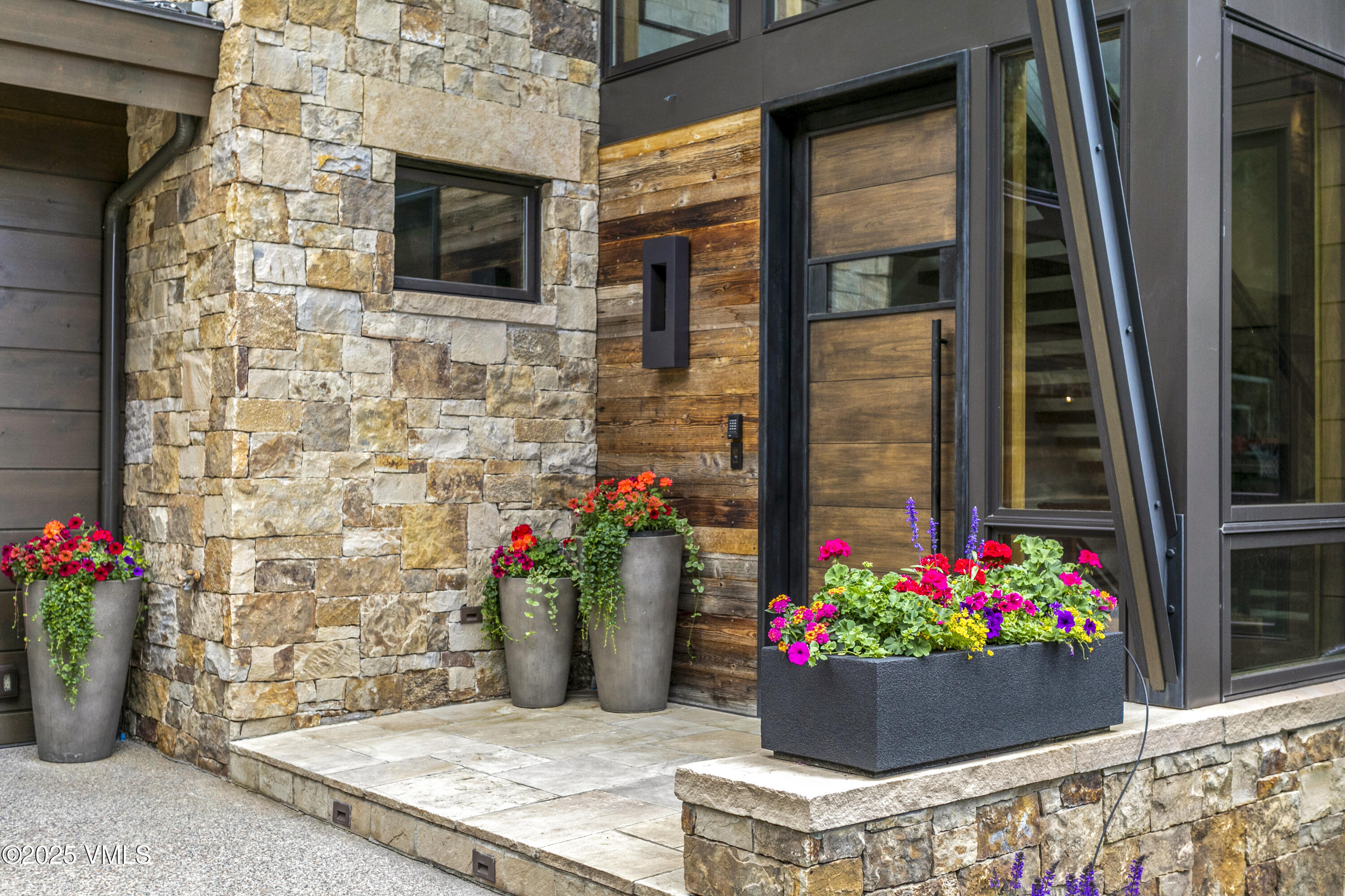 2470 Bald Mountain Road Vail, CO 81657 - Photo 3 of 29 a flower garden with flower pots