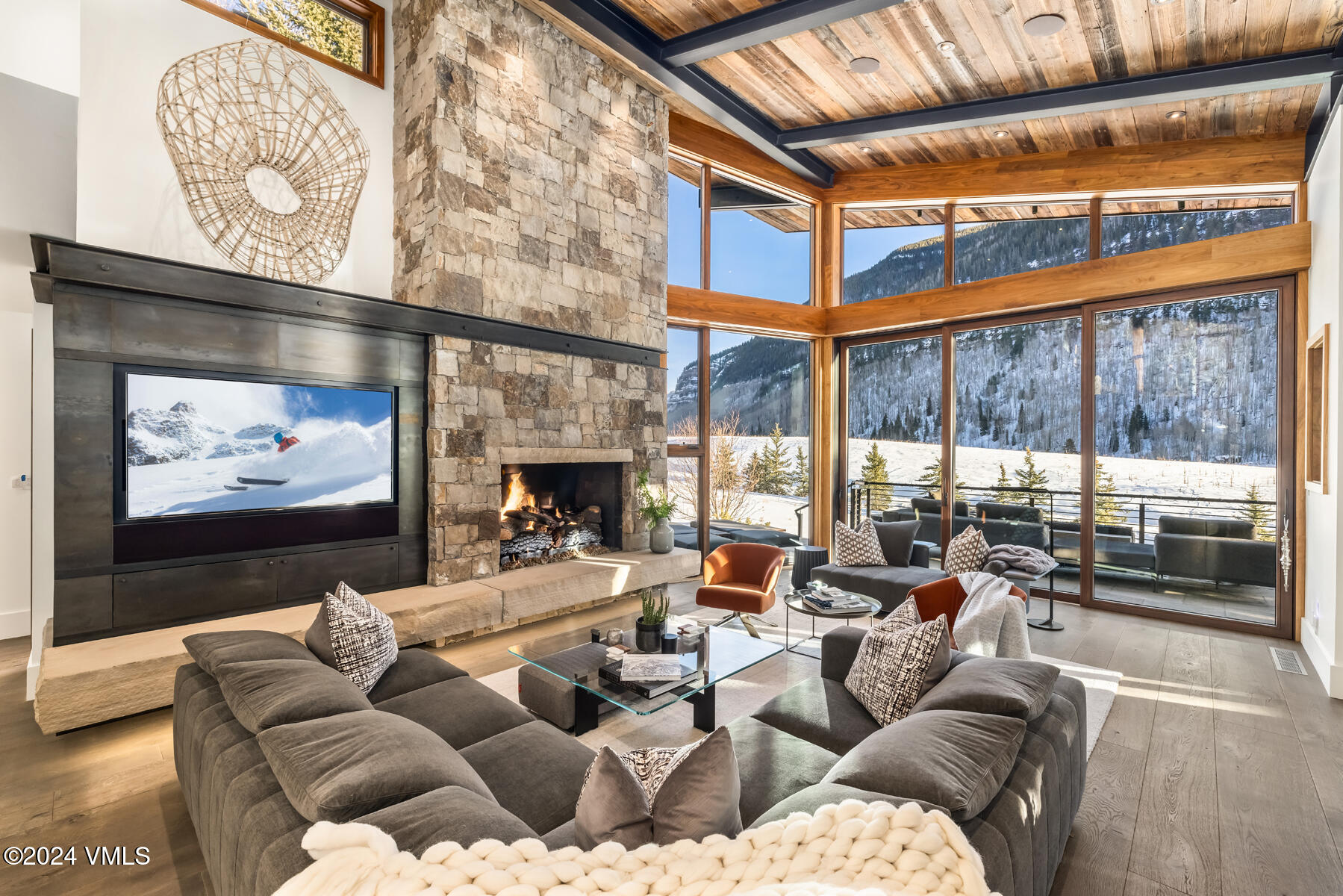 2470 Bald Mountain Road Vail, CO 81657 - Photo 6 of 29 a living room with furniture a fireplace and a flat screen tv