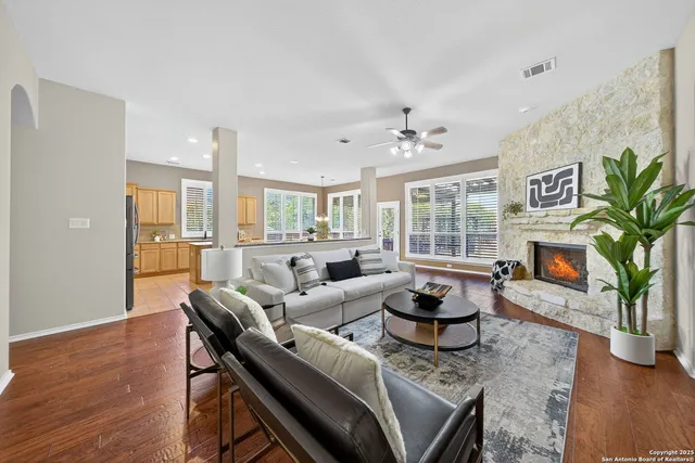 a living room with furniture potted plant and a fireplace