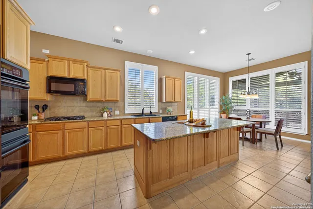 a kitchen with stainless steel appliances granite countertop sink stove and granite counter top