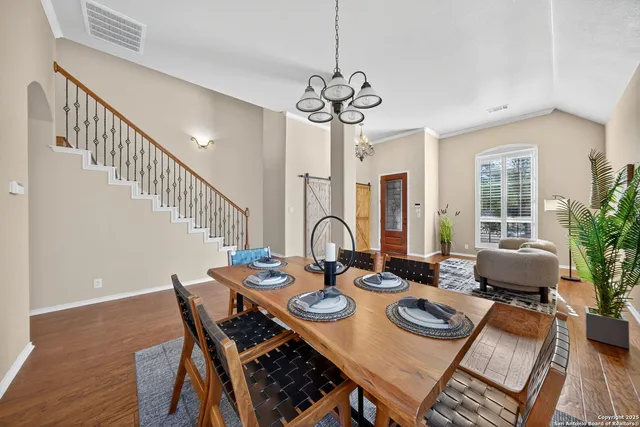 a view of a dining room with furniture window and wooden floor