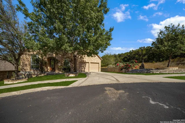 a tall yellow building with trees in the background
