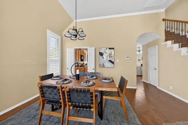 a view of a dining room with furniture wooden floor and a chandelier