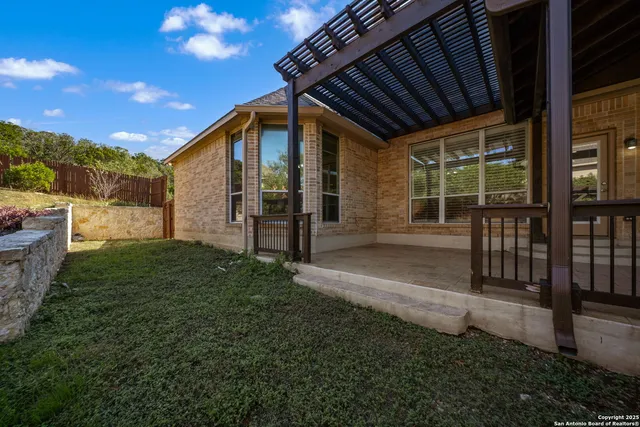 a porch with a table and chairs