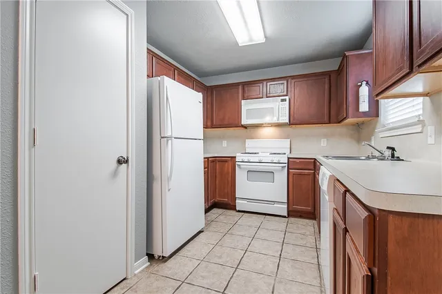 a kitchen with a stove a sink and a refrigerator