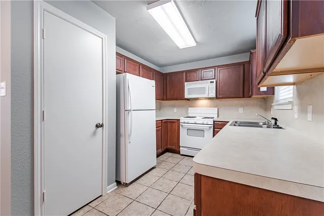 a kitchen with a refrigerator sink and stove