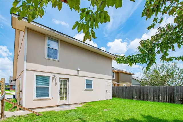 a backyard of a house with table and chairs