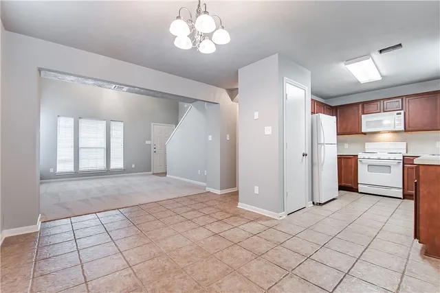 a open kitchen with cabinets and stainless steel appliances