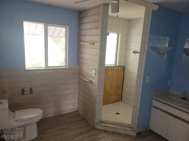 a bathroom with a toilet and a shower