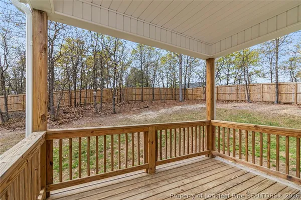 a white house that has a tree in front of it