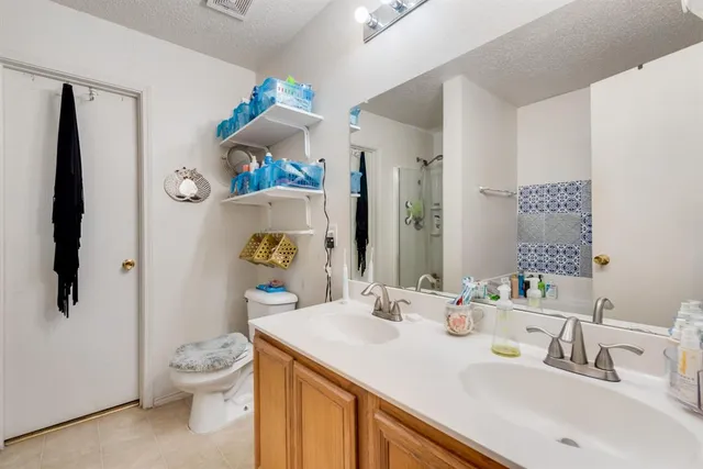a bathroom with a sink vanity mirror and toilet