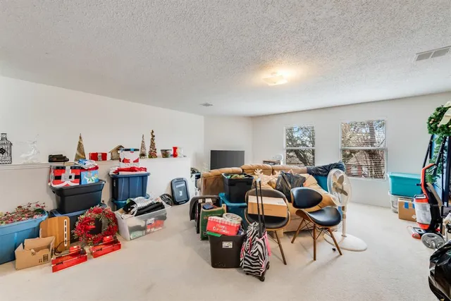 a bedroom with baby toys and a chandelier