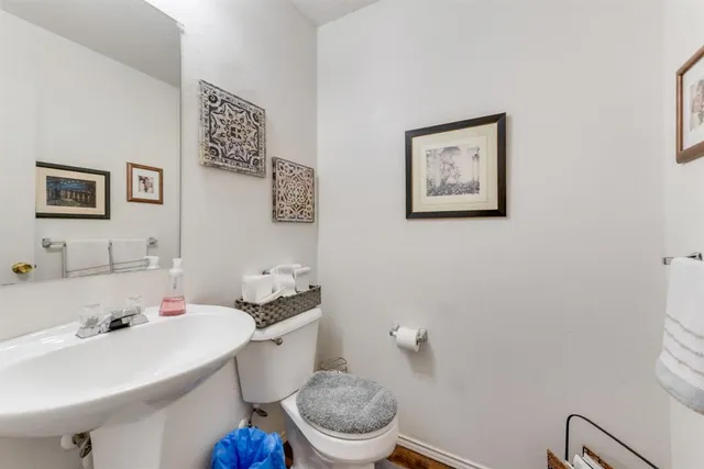 a bathroom with a sink mirror and toilet