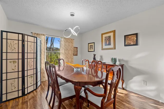a view of a dining room with furniture and wooden floor