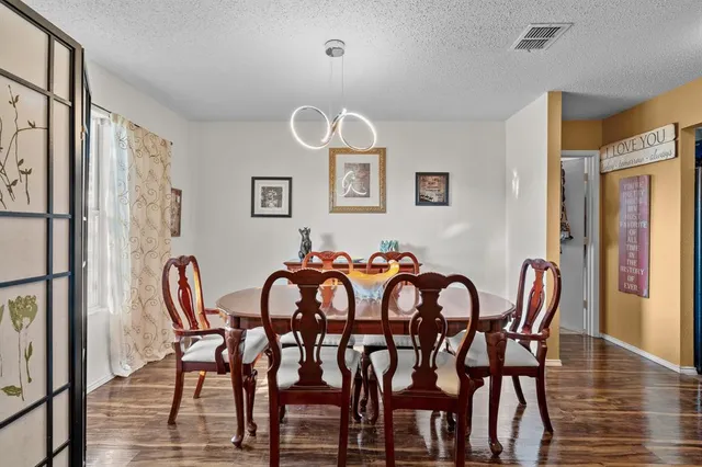 a view of a dining room with furniture and wooden floor