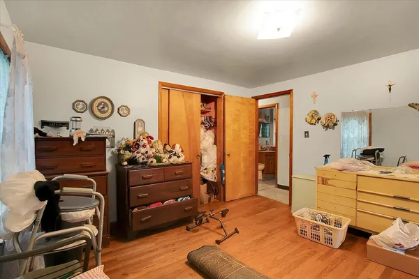 a bed room with a bed closet and a mirror
