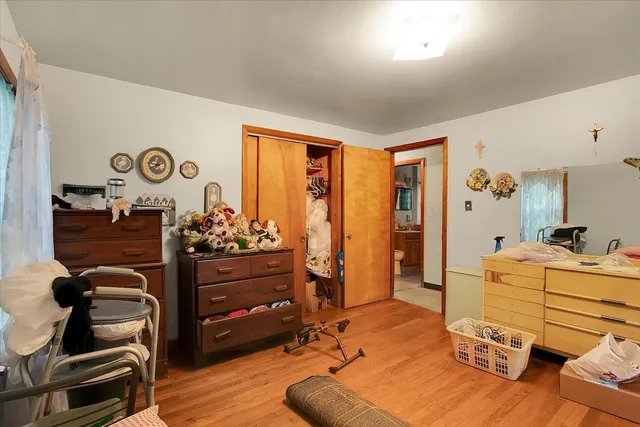 a bed room with a bed closet and a mirror