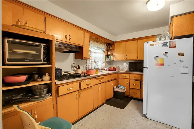 a kitchen with stainless steel appliances a stove and cabinets