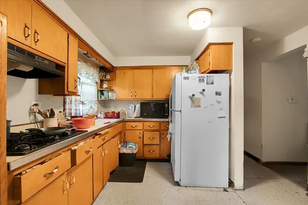a kitchen with stainless steel appliances a refrigerator a sink a stove and cabinets