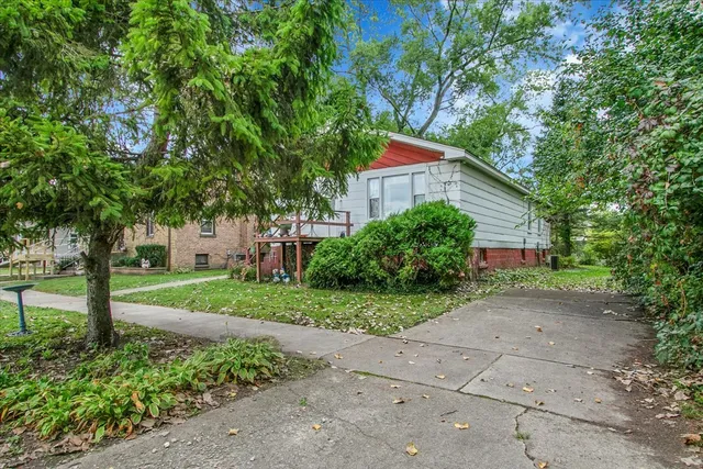 a view of a back yard with green space and plants