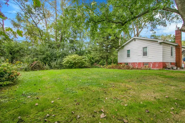 a view of an house with backyard space and garden