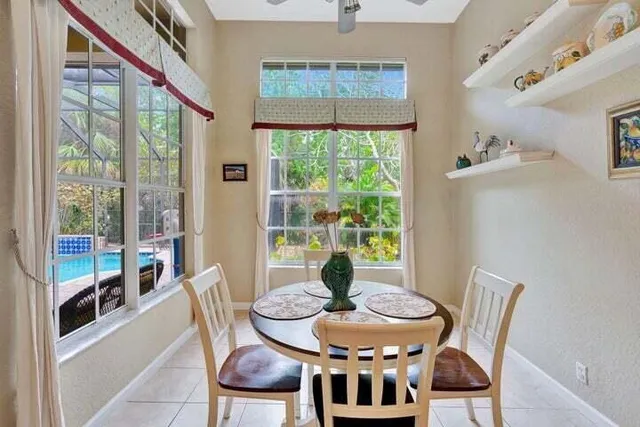 a dining room with furniture a chandelier and wooden floor