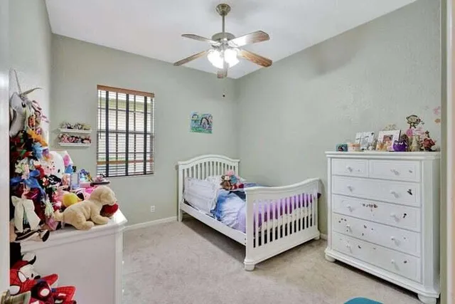 a bedroom with a bed and a baby crib