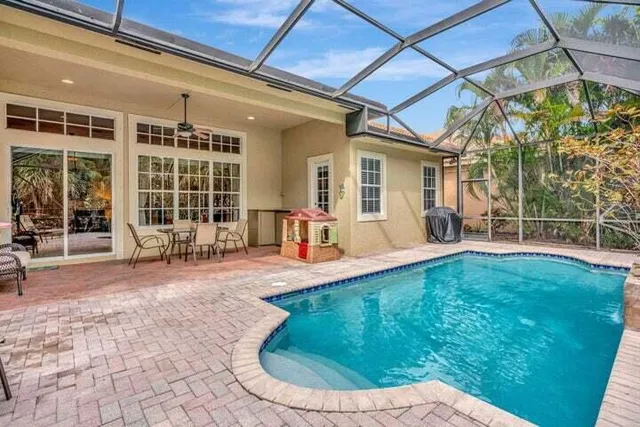 a view of a house with backyard porch and sitting area
