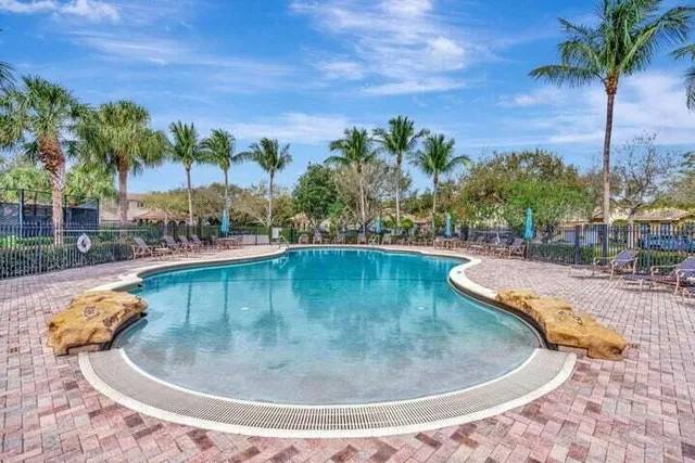 a view of a swimming pool with a yard