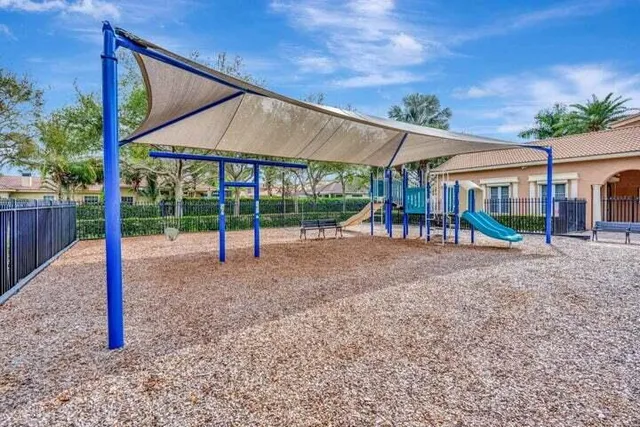 a view of a house with backyard and a patio