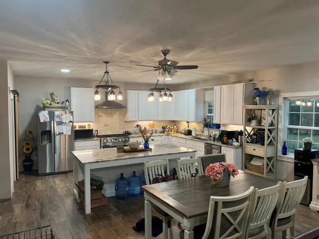 a kitchen with a table and chairs in it